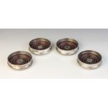 A set of three silver mounted coasters, William Comyns, London 1985, each of circular form with