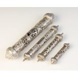 A silver coloured scroll holder, of typical form with pierced and engraved scrolling decoration, the