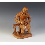 A Welsh redware glazed earthenware figure, mid 19th century, circa 1850, modelled as a seated