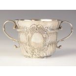 A Queen Anne silver porringer, John Cory, London, 1705, of typical form with half fluted body,