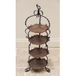 An Arts & Crafts wrought iron and copper four tier cake stand, early 20th century, the four shaped