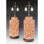 A pair of silver lustre orange lustre lamp bases, each of rectangular form upon wooden bases with