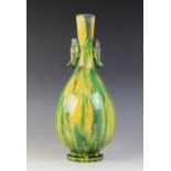 A Sancai glazed bottle vase, 20th century, possibly Awaji, the tapered bottle shaped vase with