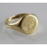 A George V 18ct gold signet ring, the central circular head with engraved monogrammed initials,