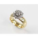 A diamond floral cluster ring, comprising a central round old cut diamond measuring approximately