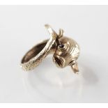 A gold coloured cocktail ring designed as a fish, with scale detail, garnets set to eyes, ring