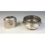 A silver coloured tea caddy, of faceted form with hinged cover and catch, elaborated engraved with