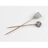 An early 20th century diamond and sapphire stick pin, the head designed as a central old cut diamond
