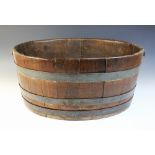 A coopered oak planter, late 19th or early 20th century, the oval body with three metal bands and
