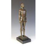 A patinated bronze figure modelled as a standing nude male with Egyptian style headdress, signed '