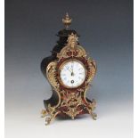 A late 19th century Louis XVI style gilt metal mounted and simulated boule mantel timepiece, of