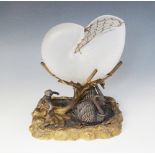 A silver plated and gilded nautilus shell centre piece, 19th century, modelled as a putto and two