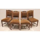 A set of four Victorian oak dining chairs, stamped H Wilson, Manchester, each chair with applied