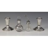 A pair of weighted silver dwarf candlesticks, each tapered sconce on spreading circular base, each