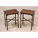 A pair of mahogany lamp tables, 20th century, the rectangular table tops with a raised rim, upon