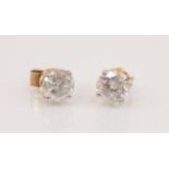 A pair of diamond solitaire earrings, each comprising a round brilliant cut diamond, each weighing