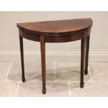 A George III demi-lune mahogany folding tea table, the top with a channelled edge opening to a