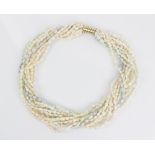 A cultured freshwater pearl necklace, comprising eleven woven strands of cultured freshwater