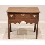 A George III oak lowboy, the rectangular moulded top above three oak lined and lip moulded drawers