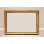A late 19th century rectangular giltwood and gesso wall mirror, the frame moulded in relief with