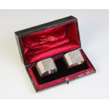 A pair of Victorian silver napkin rings, Atkin Brothers, Sheffield 1897, each of square form with