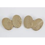 A pair of 9ct gold cufflinks, each oval form panel with foliate decoration, 18mm x 13mm, marks for