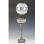 An Edwardian Adams influence silver plated oil lamp, the associated etched glass shade above a cut