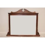 A late Victorian walnut over mantle mirror, the rectangular bevelled mirrored plate within a