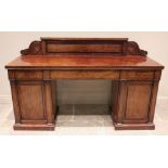 A mid 19th century twin pedestal mahogany sideboard, the raised back board extending to scroll and