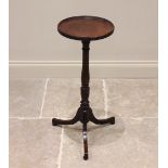 An early 19th century mahogany tripod table or candle stand, the circular top with a raised