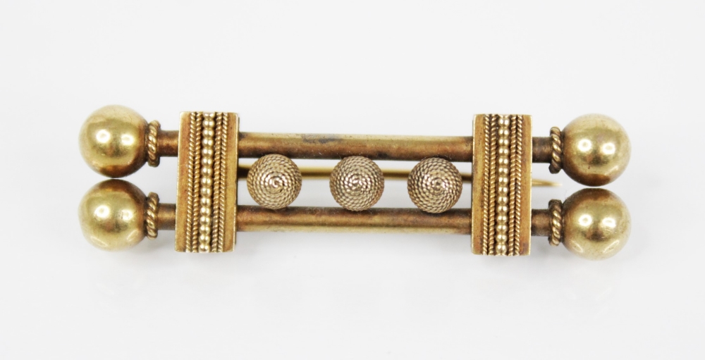 A Victorian Etruscan style gold coloured brooch, designed as two tubular bars with three rope