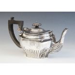A late Victorian silver teapot, Chester 1899 (maker's mark worn), of inverted baluster faceted form,