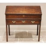 A George III oak clerk?s desk, the hinged slope opening to two small drawers and a pigeon hole,