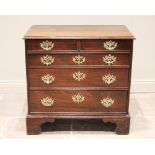 A mid 18th century oak chest of drawers, formed as four long graduated drawers (later re-