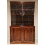 A large Regency mahogany library bookcase, the cavetto cornice above a plain frieze and a pair of