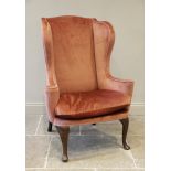 A George III wing back fireside armchair, later re-covered in pink velour with applied rope