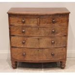 A mid 19th century bow front mahogany chest of drawers, formed from two short over three long