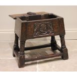A 17th century and later hinged oak joint stool, the rectangular moulded hinged top above a front