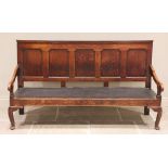 A George III oak five panel settle, the moulded back rail above five invert moulded panels and a