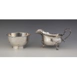 A George V silver sauce boat by E S Barnsley & Co, Birmingham 1918, of bellied form with shaped