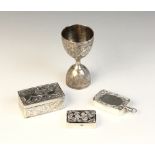 An Indian silver coloured double-ended spirit measure, of typical form with scrolling foliate