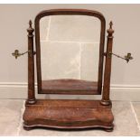 A mid 19th century burr walnut toilet mirror, the arched mirror raised upon tapering cylindrical