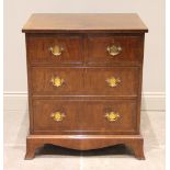 An early 20th century walnut chest of drawers, the burr walnut book veneered and cross banded top,