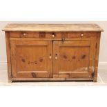 A Victorian pine kitchen dresser base, the rectangular board top over two frieze drawers and two