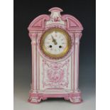 A late 19th century Gien pottery mantel clock, the architectural case highlighted with pink and