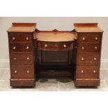 A Victorian mahogany twin pedestal dressing table/writing desk, the 'dropped' bowfront centre with a