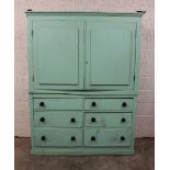 A 19th century painted pine housekeepers cupboard, the moulded cornice above a pair of relief