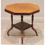 An Edwardian walnut octagonal library table, the top with a lobed frieze raised upon four turned