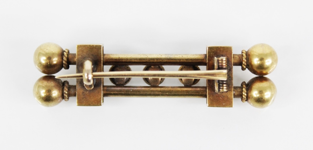 A Victorian Etruscan style gold coloured brooch, designed as two tubular bars with three rope - Image 2 of 2