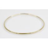 An 18ct gold bangle, marks for Sheffield 2000, of plain polished circular form, 6.8cm wide, weight
